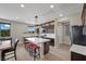 Modern kitchen with dark wood cabinets, large island, and stainless steel appliances at 5594 Trilling Bird Dr, Las Vegas, NV 89135