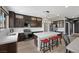 Kitchen featuring stainless appliances, an island with seating, and dark wood cabinetry at 5594 Trilling Bird Dr, Las Vegas, NV 89135