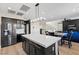 Modern kitchen with stainless steel appliances, an island, and open to living area at 5594 Trilling Bird Dr, Las Vegas, NV 89135