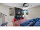 Comfortable living room features stylish black wall, plush blue sofa, and colorful rug for relaxing and entertaining at 5594 Trilling Bird Dr, Las Vegas, NV 89135