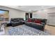 Spacious living room with modern furnishings, including a comfortable sofa and stylish area rug at 5594 Trilling Bird Dr, Las Vegas, NV 89135