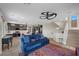 Open-concept living room with modern furnishings, wood floors, and seamless connection to the kitchen and dining area at 5594 Trilling Bird Dr, Las Vegas, NV 89135