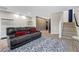 Living room with plush seating, modern decor, and access to the upper level at 5594 Trilling Bird Dr, Las Vegas, NV 89135