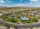 Aerial view showcasing neighborhood homes with community pool and mountain views at 5594 Trilling Bird Dr, Las Vegas, NV 89135