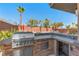 Outdoor kitchen featuring a built-in grill and stone countertops, perfect for entertaining under the clear sky at 5594 Trilling Bird Dr, Las Vegas, NV 89135