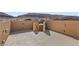 Expansive rooftop patio with desert views, bordered by high stucco walls for privacy at 5594 Trilling Bird Dr, Las Vegas, NV 89135