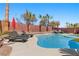 Inviting pool area with comfortable lounge chairs, offering a relaxing outdoor retreat at 5594 Trilling Bird Dr, Las Vegas, NV 89135