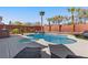 Sparkling pool and spa surrounded by lush landscaping, creating a private backyard oasis at 5594 Trilling Bird Dr, Las Vegas, NV 89135