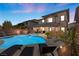 Inviting backyard oasis featuring a pool, spa, and outdoor seating, perfect for entertaining in a luxury home at 5594 Trilling Bird Dr, Las Vegas, NV 89135