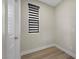 Bright, minimal room featuring a window with blinds and a white door at 5594 Trilling Bird Dr, Las Vegas, NV 89135