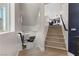 Contemporary staircase leading to an open floor plan with views of the living room and kitchen at 5594 Trilling Bird Dr, Las Vegas, NV 89135