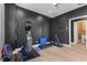 Contemporary workout room includes exercise equipment and sleek black textured walls for a modern exercise experience at 5594 Trilling Bird Dr, Las Vegas, NV 89135