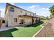Backyard with artificial turf, stone retaining walls, and a covered patio at 6236 Mount Palomar Ave, Las Vegas, NV 89139