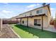 Expansive backyard boasts artificial grass, a covered patio, and convenient sliding door access to the home at 6236 Mount Palomar Ave, Las Vegas, NV 89139
