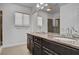 Bathroom featuring double sinks, a marble countertop, and a glass shower enclosure at 6236 Mount Palomar Ave, Las Vegas, NV 89139