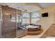 Elegant bathroom boasts a glass shower, garden tub, and dual sinks with granite counters at 6236 Mount Palomar Ave, Las Vegas, NV 89139