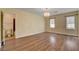 Spacious bedroom with hardwood flooring, chandelier lighting, and natural sunlight at 6236 Mount Palomar Ave, Las Vegas, NV 89139