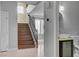 Inviting entryway featuring hardwood stairs, contemporary lighting, and a pedestal sink at 6236 Mount Palomar Ave, Las Vegas, NV 89139