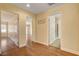 Hallway with wood-look floors with multiple doorways to rooms and bathrooms at 6236 Mount Palomar Ave, Las Vegas, NV 89139
