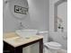 Chic powder room featuring a bowl sink, modern fixtures, and a decorative mirror at 6236 Mount Palomar Ave, Las Vegas, NV 89139