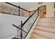Staircase features sleek dark wood and wrought iron bannister, leading to a bright second floor at 6236 Mount Palomar Ave, Las Vegas, NV 89139