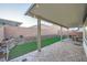 Charming backyard featuring a covered patio and low-maintenance landscaping at 6445 N Alpine Ridge Way, Las Vegas, NV 89149