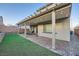 Landscaped backyard with a covered patio area for outdoor relaxation at 6445 N Alpine Ridge Way, Las Vegas, NV 89149