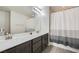 Well-lit bathroom featuring a double sink vanity and a shower-tub combination at 6445 N Alpine Ridge Way, Las Vegas, NV 89149