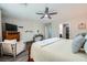 Inviting bedroom with wood-look floors, a ceiling fan, and plenty of natural light at 6445 N Alpine Ridge Way, Las Vegas, NV 89149