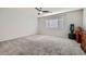 Spacious bedroom with plush carpeting, neutral walls, and a ceiling fan at 6445 N Alpine Ridge Way, Las Vegas, NV 89149