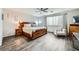 Cozy bedroom with wood-look floors, a ceiling fan, and tasteful decor at 6445 N Alpine Ridge Way, Las Vegas, NV 89149
