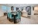Open-concept dining area with stylish seating, seamlessly connected to a modern kitchen and living space at 6445 N Alpine Ridge Way, Las Vegas, NV 89149