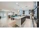 Open-concept kitchen featuring a large island, modern appliances, and seamless flow to the living area at 6445 N Alpine Ridge Way, Las Vegas, NV 89149