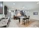 Bright and open kitchen with an island, dark cabinets, stainless steel appliances, and tiled floors at 6445 N Alpine Ridge Way, Las Vegas, NV 89149