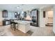 Spacious kitchen with dark cabinetry, a granite island, stainless steel appliances, and ample counter space at 6445 N Alpine Ridge Way, Las Vegas, NV 89149