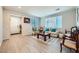 Bright living room featuring neutral walls, tiled floors, and stylish furniture arrangement at 6445 N Alpine Ridge Way, Las Vegas, NV 89149