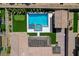 An aerial perspective reveals a backyard oasis featuring a pool, spa, putting green, and covered patio at 7095 Falabella Ridge Ave, Las Vegas, NV 89131
