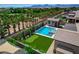Backyard features a pool, spa, putting green, and lush landscaping in this beautiful aerial view at 7095 Falabella Ridge Ave, Las Vegas, NV 89131