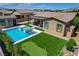 Aerial picture of backyard features a swimming pool, spa, putting green, and detached cabana at 7095 Falabella Ridge Ave, Las Vegas, NV 89131