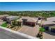 An aerial view of a home showcases its manicured landscaping, tile roof, and convenient three-car garage at 7095 Falabella Ridge Ave, Las Vegas, NV 89131
