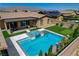 Aerial shot of a backyard featuring a swimming pool, spa, putting green, and covered patio area at 7095 Falabella Ridge Ave, Las Vegas, NV 89131