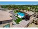 Aerial image shows a pool, spa, putting green, cabana, and large patio in the backyard at 7095 Falabella Ridge Ave, Las Vegas, NV 89131