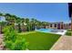Beautiful backyard featuring a pool, putting green, and lush landscaping, perfect for outdoor enjoyment at 7095 Falabella Ridge Ave, Las Vegas, NV 89131