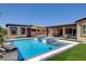 Spacious backyard highlighting a pool, spa, lush landscaping, and outdoor living areas at 7095 Falabella Ridge Ave, Las Vegas, NV 89131
