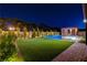 Expansive backyard with a putting green, sparkling pool, and manicured landscaping for outdoor enjoyment at 7095 Falabella Ridge Ave, Las Vegas, NV 89131