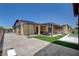 Large backyard with a covered patio, well-maintained landscaping, and a sparkling pool and spa at 7095 Falabella Ridge Ave, Las Vegas, NV 89131