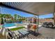 Inviting outdoor space with a covered patio, pool, spa, and a charming cabana at 7095 Falabella Ridge Ave, Las Vegas, NV 89131