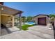 Backyard view featuring a covered patio, a detached cabana, pool and well-maintained landscaping at 7095 Falabella Ridge Ave, Las Vegas, NV 89131
