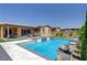 Beautiful backyard showcasing a pool, spa, well-manicured lawn and landscaping at 7095 Falabella Ridge Ave, Las Vegas, NV 89131