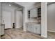 Stylish gray dry bar featuring granite countertops and glass shelving, perfect for entertaining at 7095 Falabella Ridge Ave, Las Vegas, NV 89131